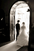 bride and groom standing in archway after wedding